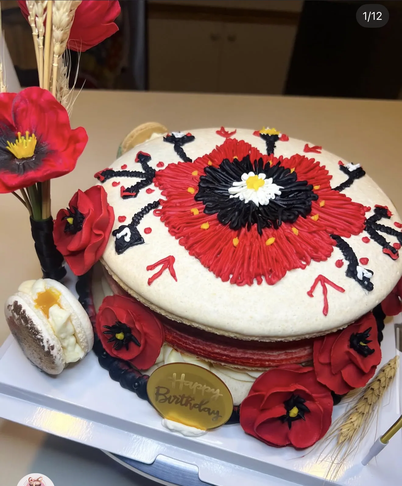 Hand-piped red poppy and black buttercream cake in Ukrainian folk style with wheat and poppies