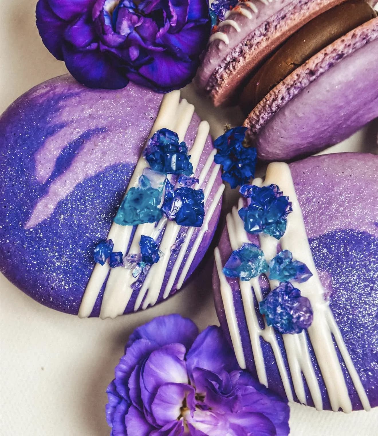 Layered purple amethyst macarons with crystal detail and violet carnation accents