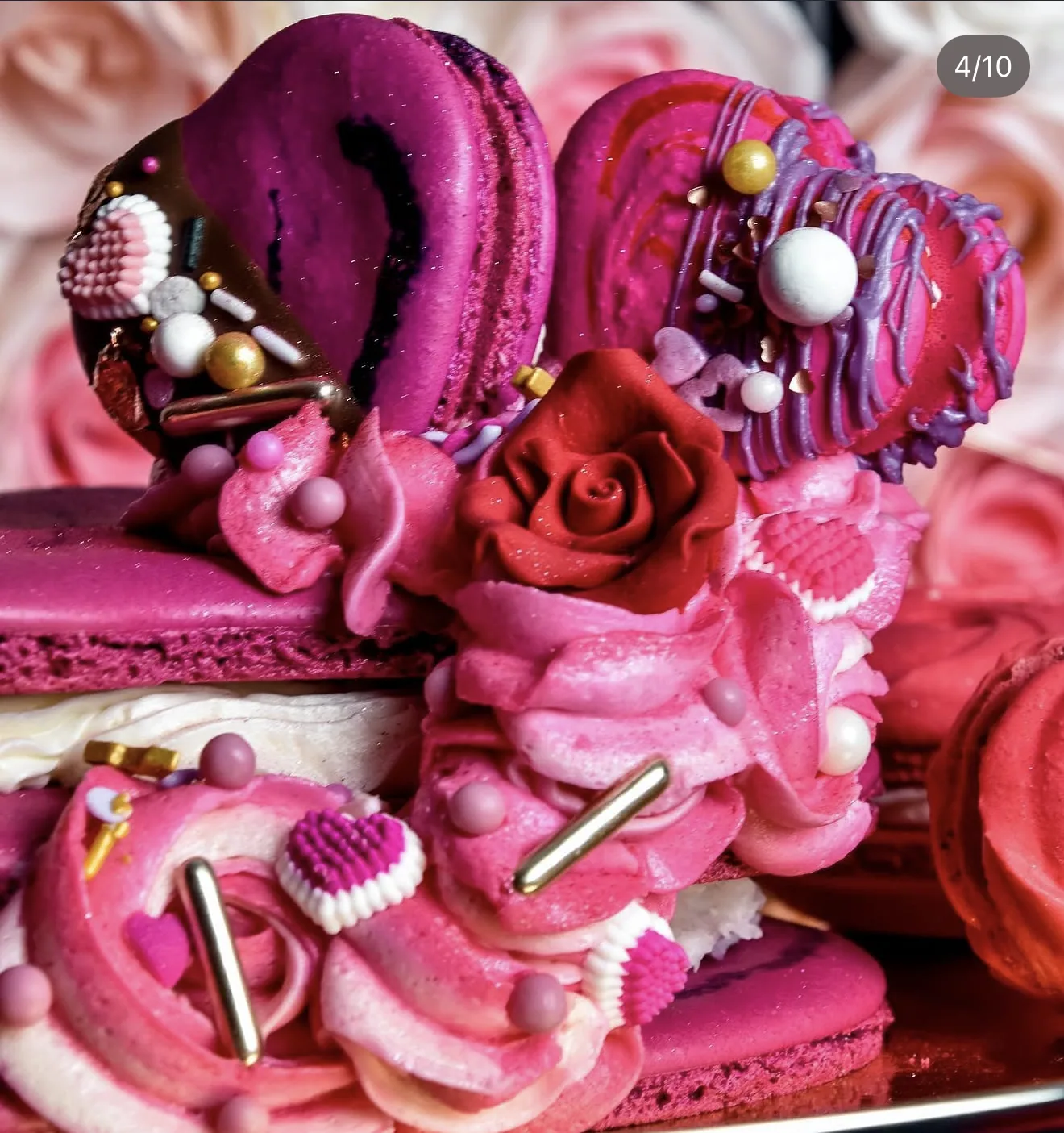Pink Valentines dessert cluster with heart-shaped macarons piped cream red sugar rose and pearls