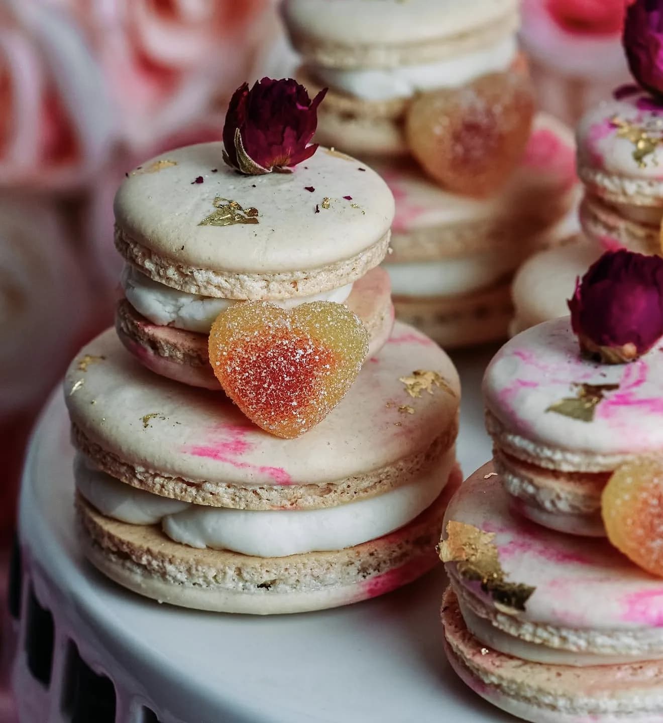 Coral glaze cake with passionfruit halves purple orchids marigolds on rustic wood round