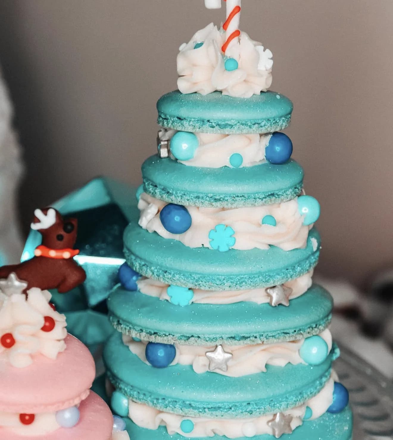 Pink macaron Christmas tree with silver stars snowflakes and candy cane topper on navy bauble