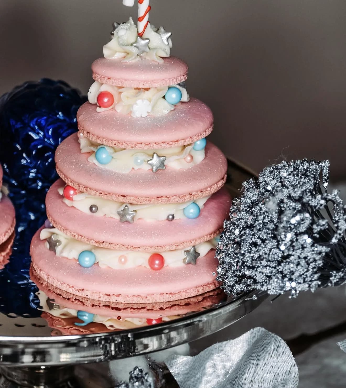 Chocolate ganache drip cake topped with earth donut rocket blue spheres berries and burlap banner
