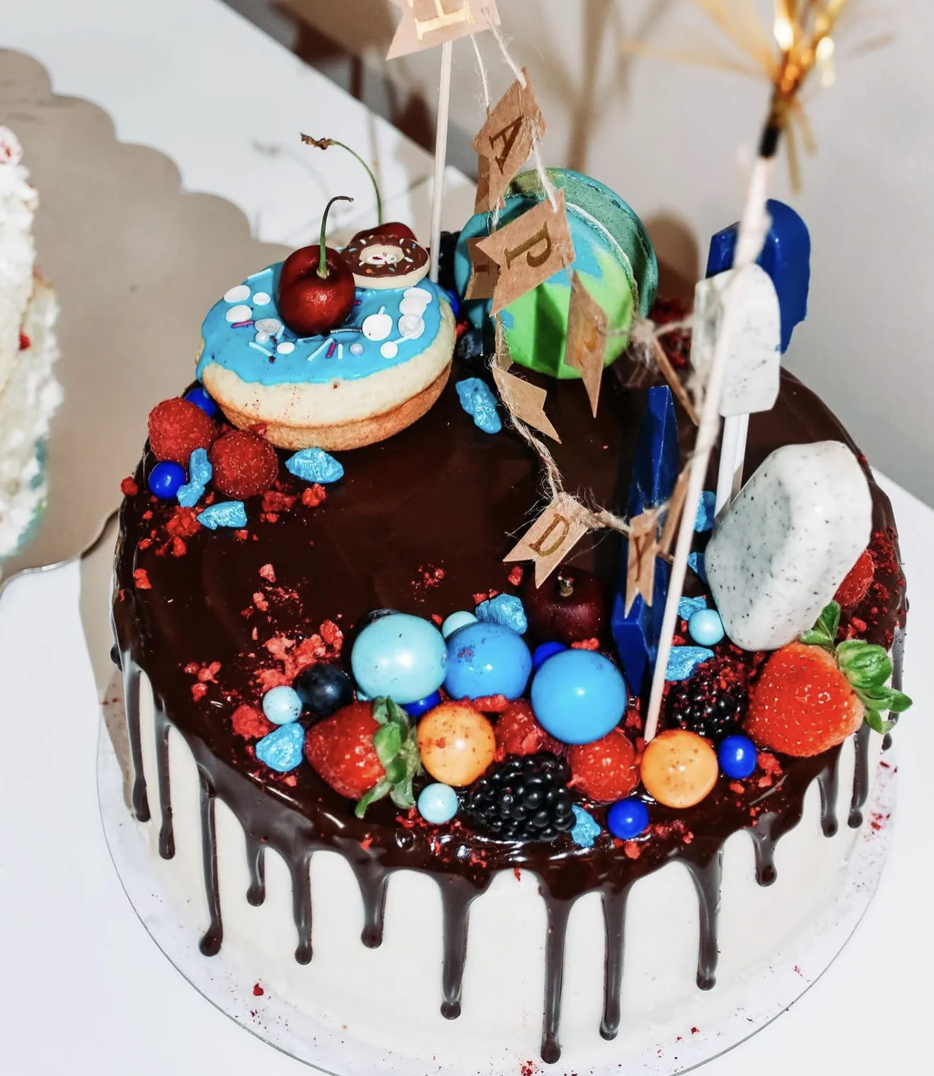 Number one shaped space cake with earth donut E&J whiskey bottle mini and blue planet candies