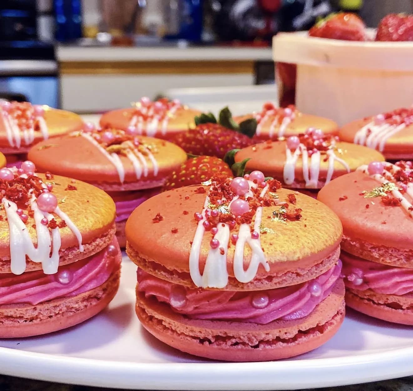 Yellow cake with passionfruit drip macaron toppers and bouquet of marigolds and coral blooms