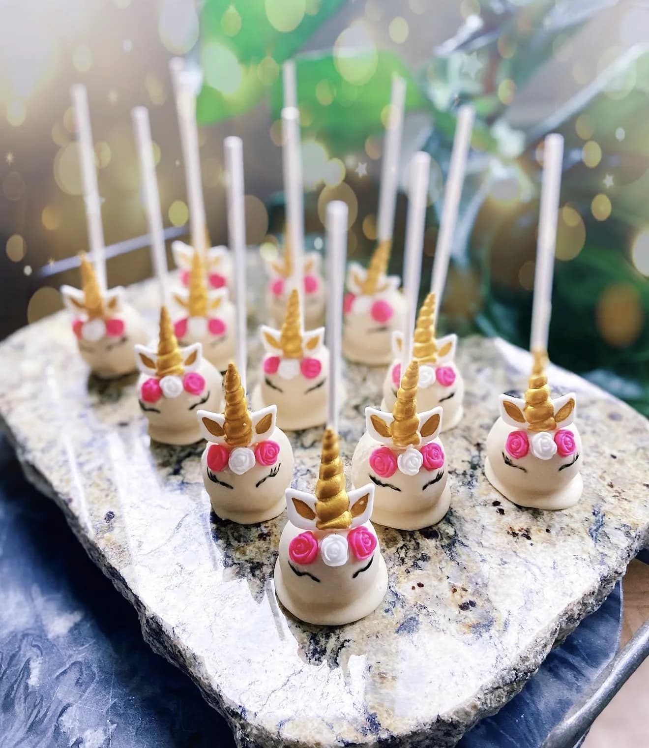 Alternate view of unicorn cake pops with gold horns pink rose crowns and drawn lashes